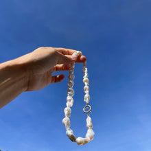Load image into Gallery viewer, A baroque pearl necklace made of irregular white and pale grey pearls with a silver clasp